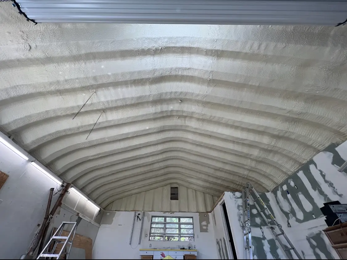 Spray polyurethane foam applied to the underside of a metal roof deck in Live Oak